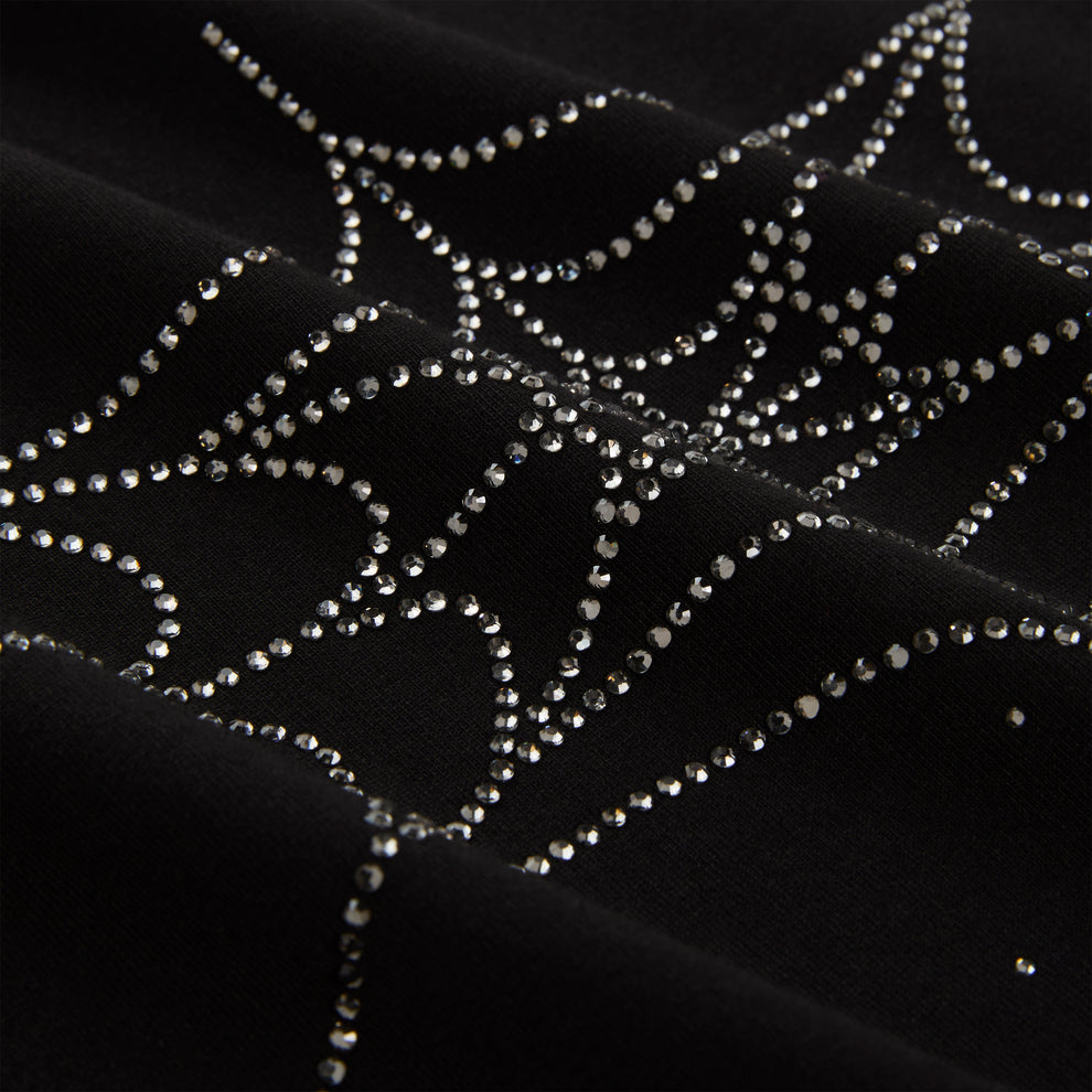 Black cotton tee with sparkling rhinestone spiderweb graphic.