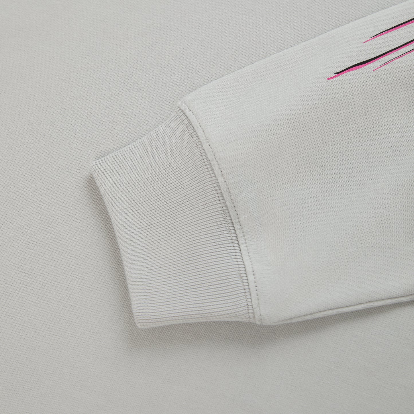 Light gray cotton long sleeve tee with ribbed cuff and pink/black graphic print detail.