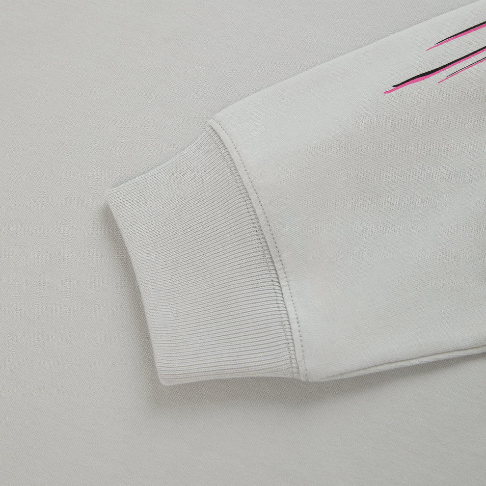 Light gray cotton long sleeve tee with ribbed cuff and pink/black graphic print detail.