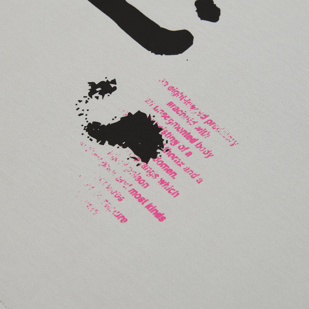 White cotton long sleeve tee with black and pink graphic print detail.