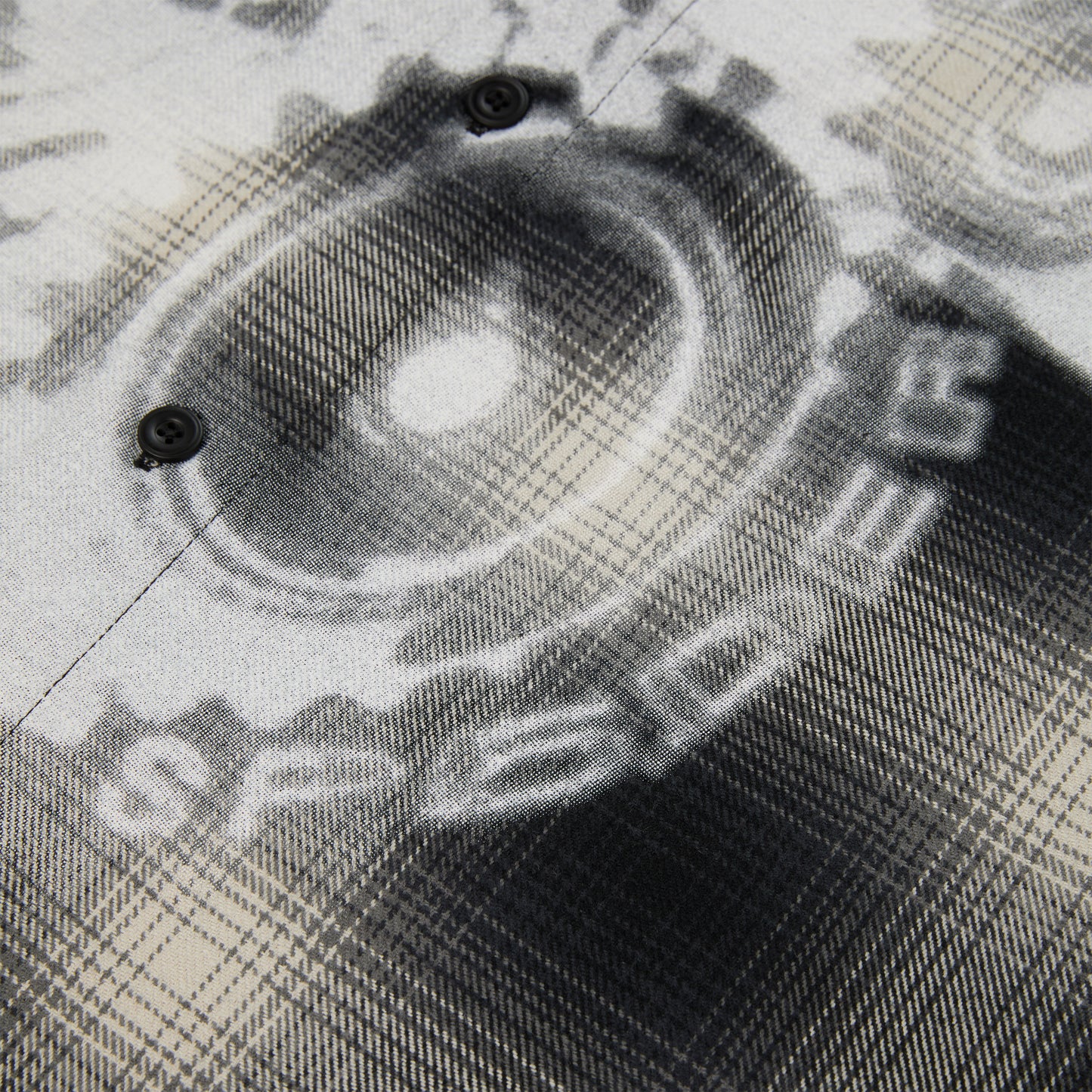 Cotton flannel shirt with black and white faded graphic print and button closure.