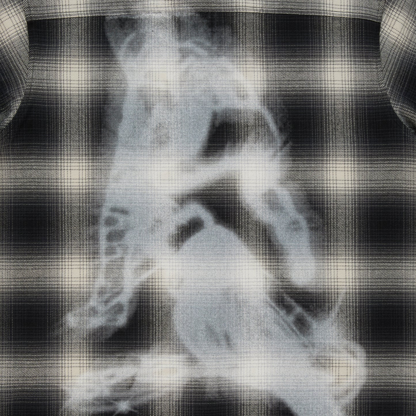 Black and cream plaid cotton flannel shirt with a faded graphic print on the back.