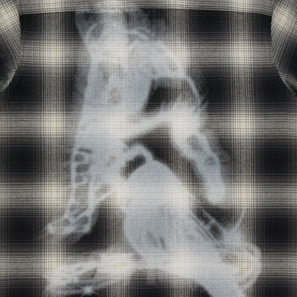 Black and cream plaid cotton flannel shirt with a faded graphic print on the back.