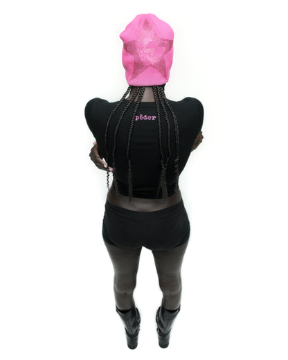 Black cropped MOTO 5 BABY TEE with pink 'SP5DER' logo on back neck, worn with black shorts and boots.
