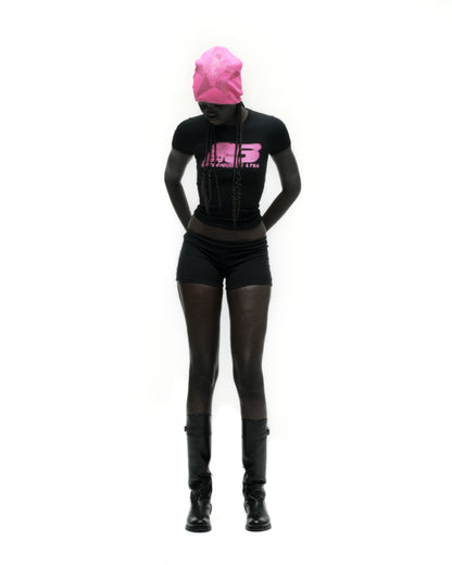 Black cropped MOTO 5 BABY TEE with pink graphic print, worn by a model with a matching pink beanie.