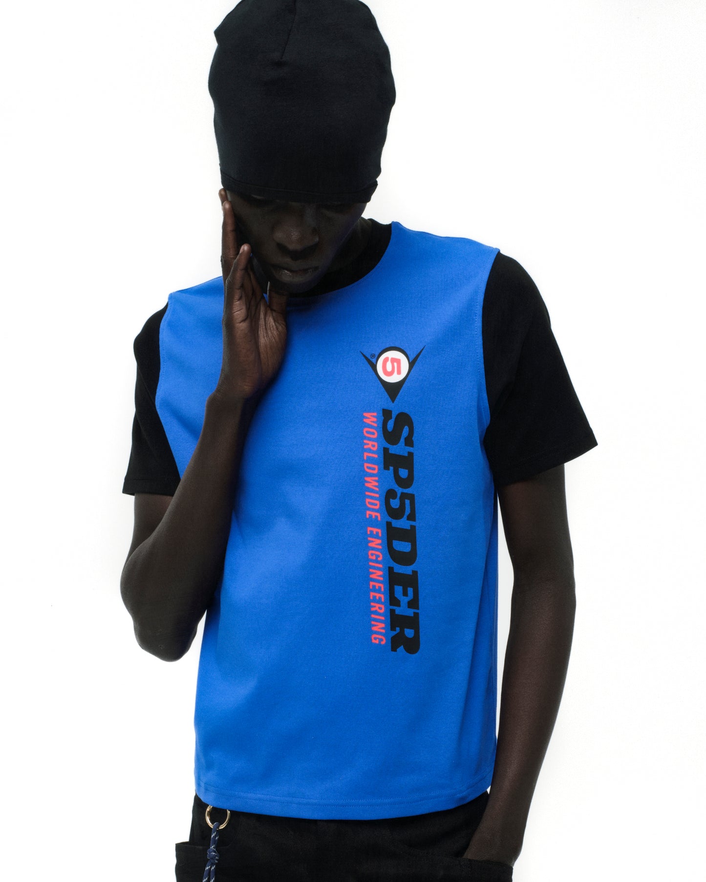 Black tee with blue overlay, "SPSDER WORLDWIDE ENGINEERING" graphic, worn by a person in a black beanie.