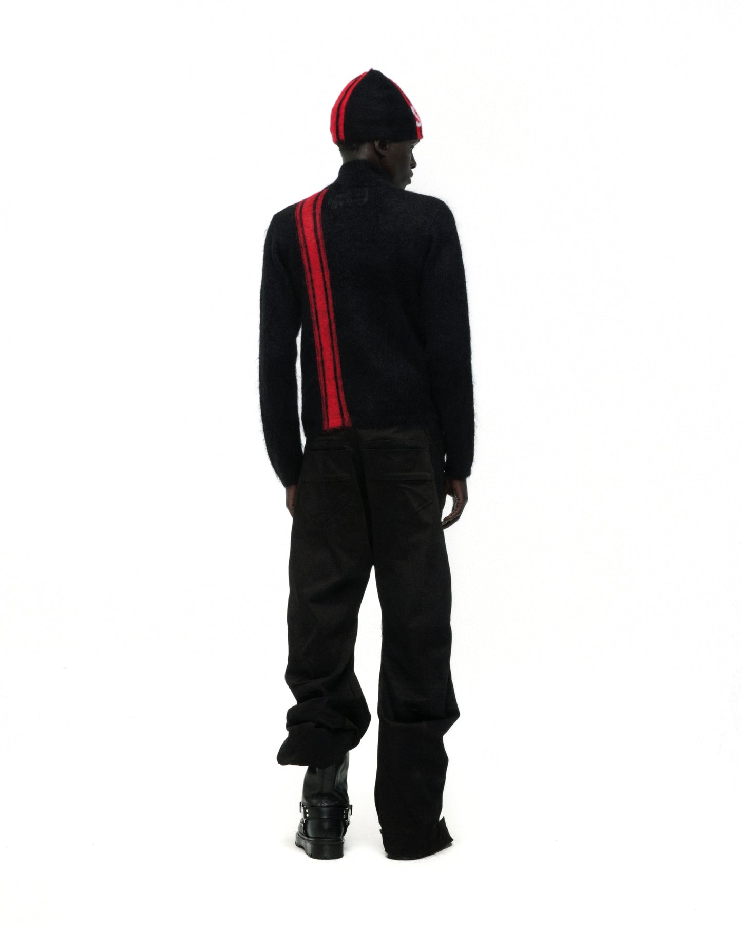 Black mohair knit zip sweater with a red vertical stripe, worn with a matching beanie.