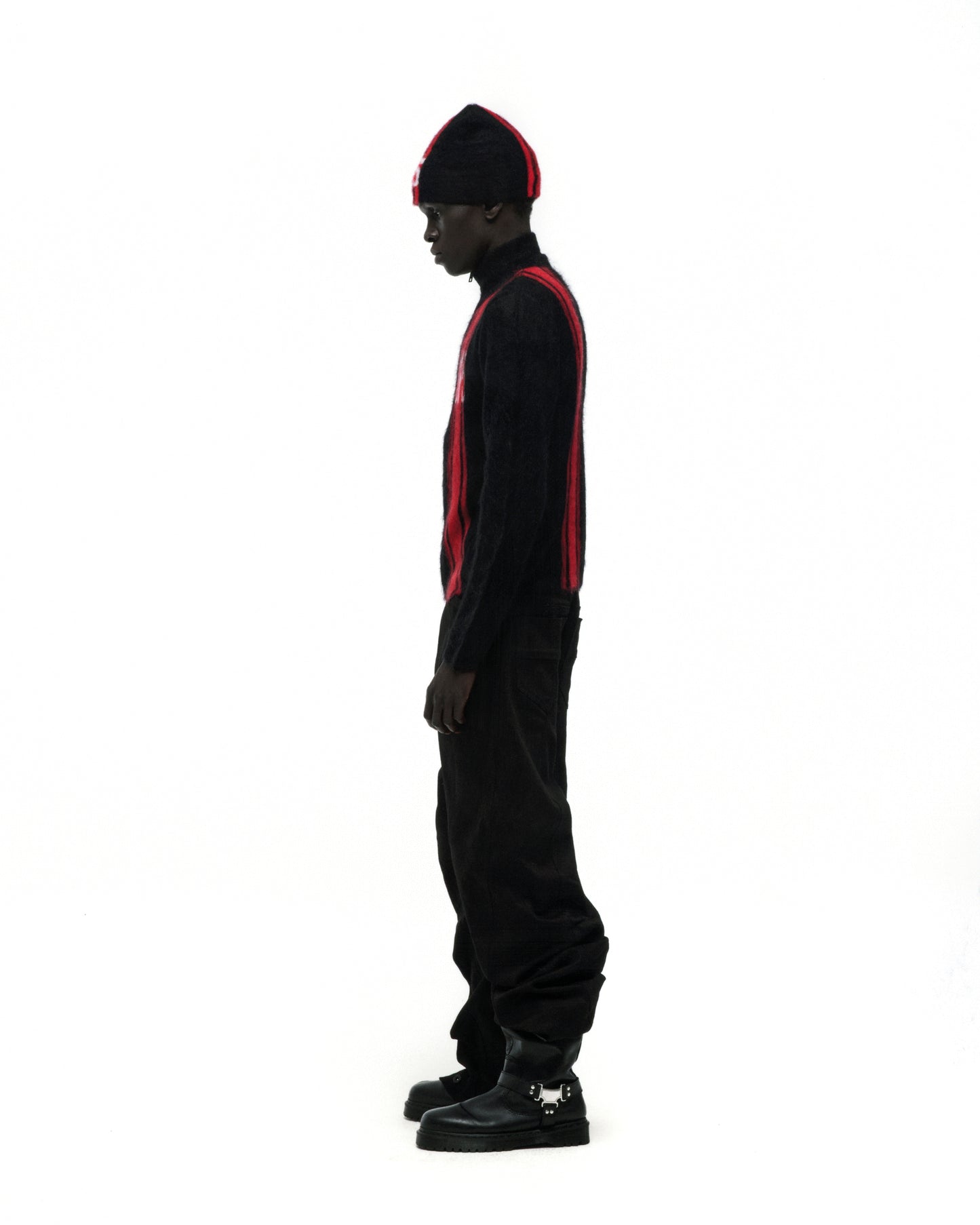 Black mohair knit zip sweater with red vertical stripes, stand collar, and "SP5" logo.