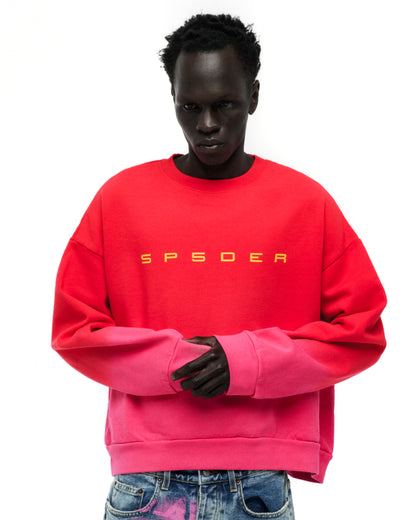 Red and pink gradient crewneck with yellow "SP5DER" text on chest, worn by a model.
