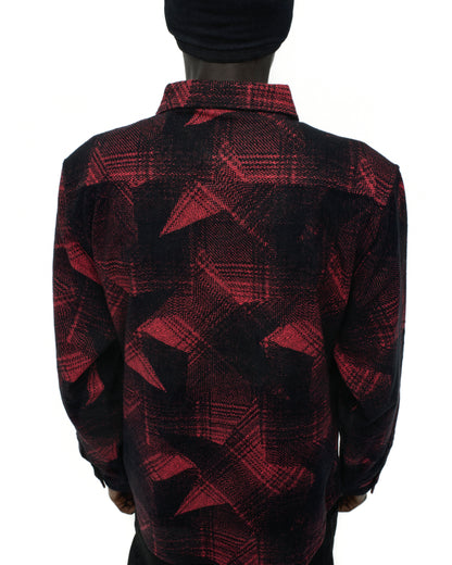 Back of a red and black cotton flannel shirt with a plaid and paneled SP5 graphic design.