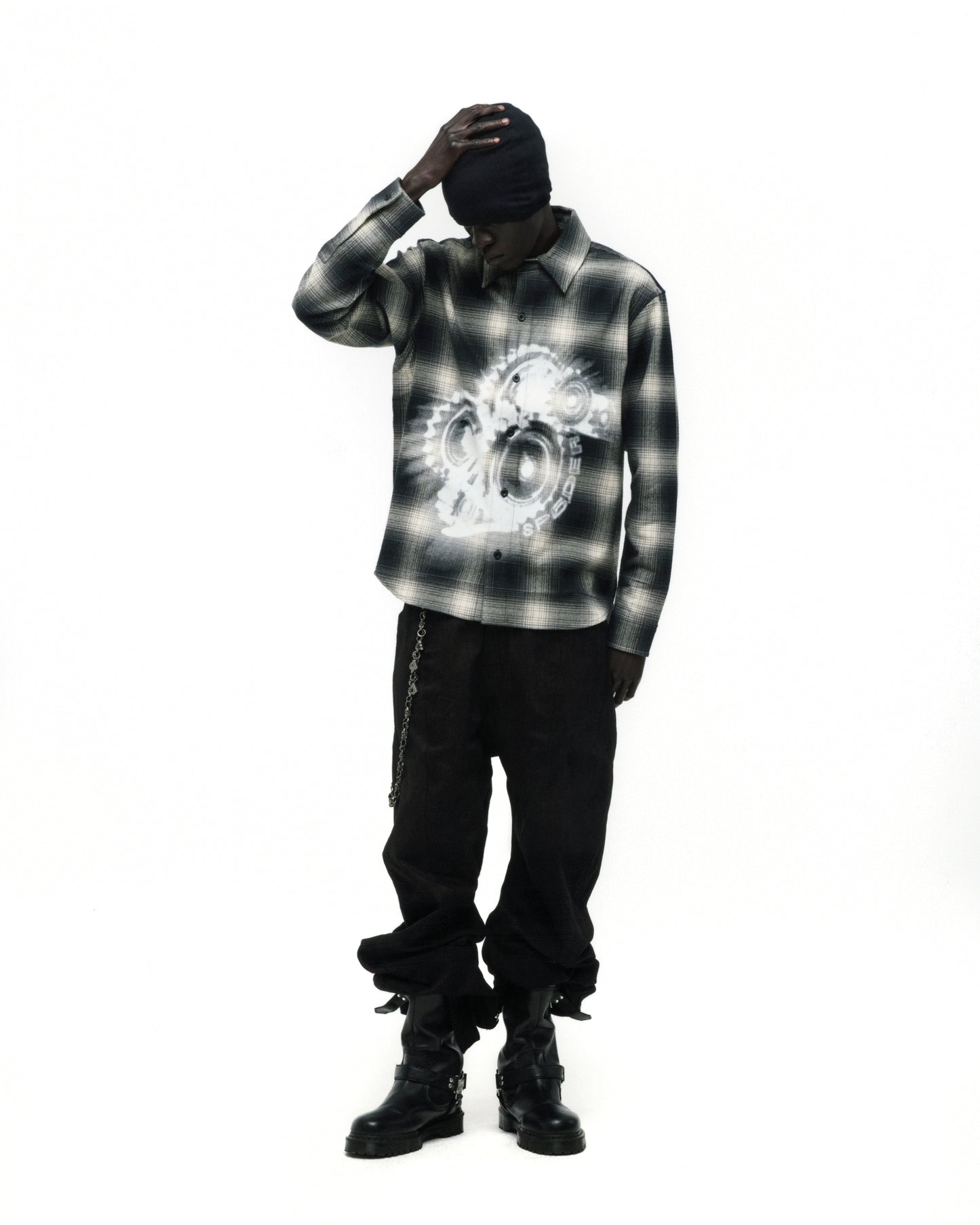 Burnout Flannel: Black and white plaid cotton shirt with faded graphic print, worn by a model.