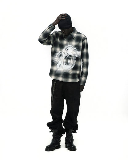 Burnout Flannel: Black and white plaid cotton shirt with faded graphic print, worn by a model.