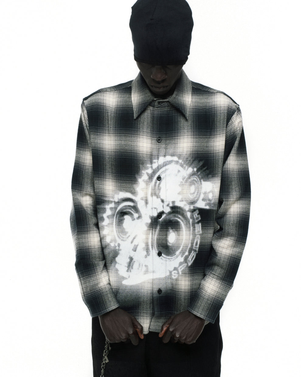 Black and white plaid cotton flannel shirt with faded gear graphic print on front.