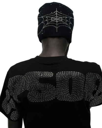 Black acrylic skully with rhinestone spiderweb design on front and back, worn by a person facing away.