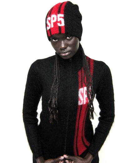 Black mohair knit zip sweater with red vertical stripes and "SP5" logo, worn by a model.