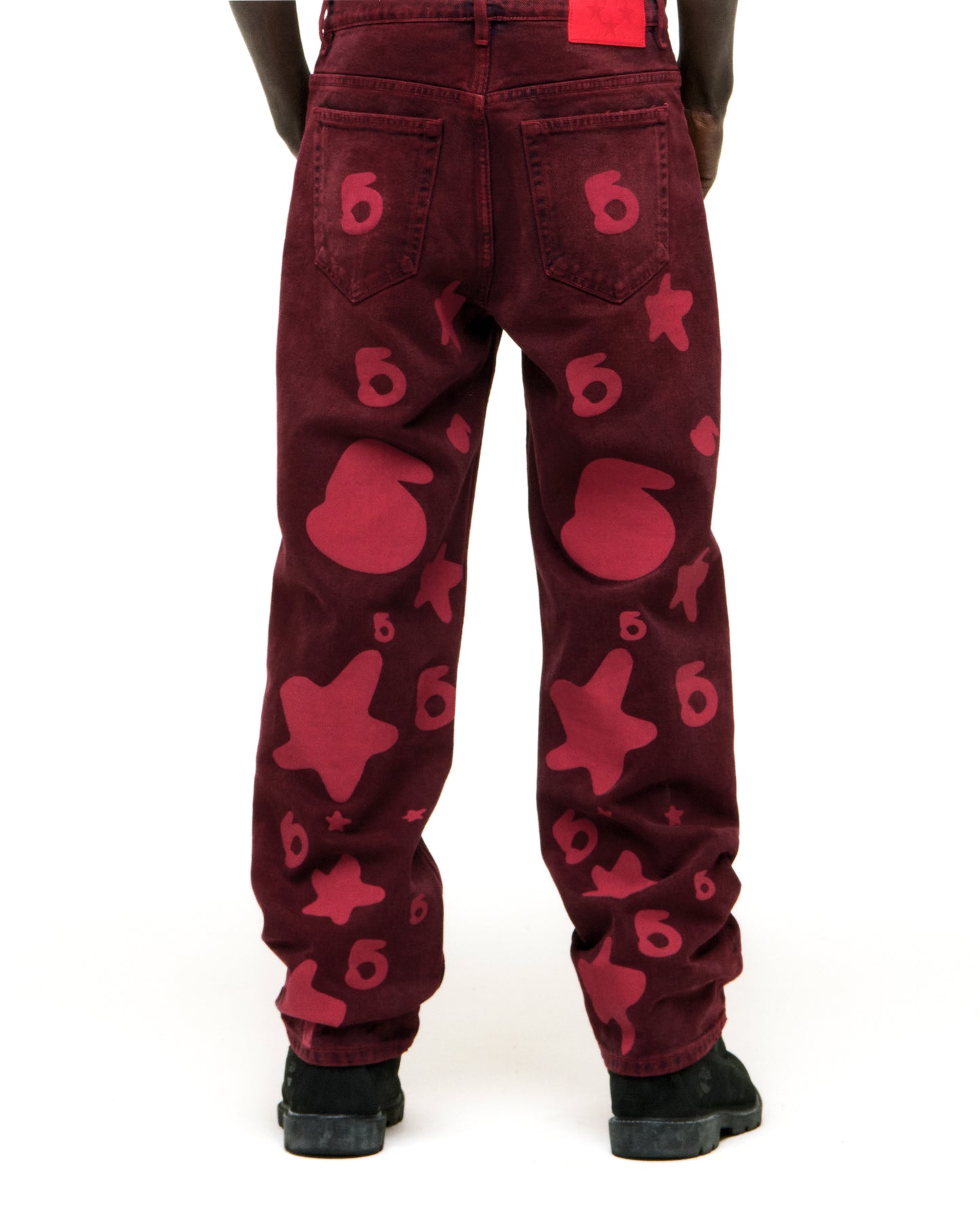 BELUGA DENIM faded wash red jeans with custom "6" and star print, branded back patch, and classic straight leg fit.