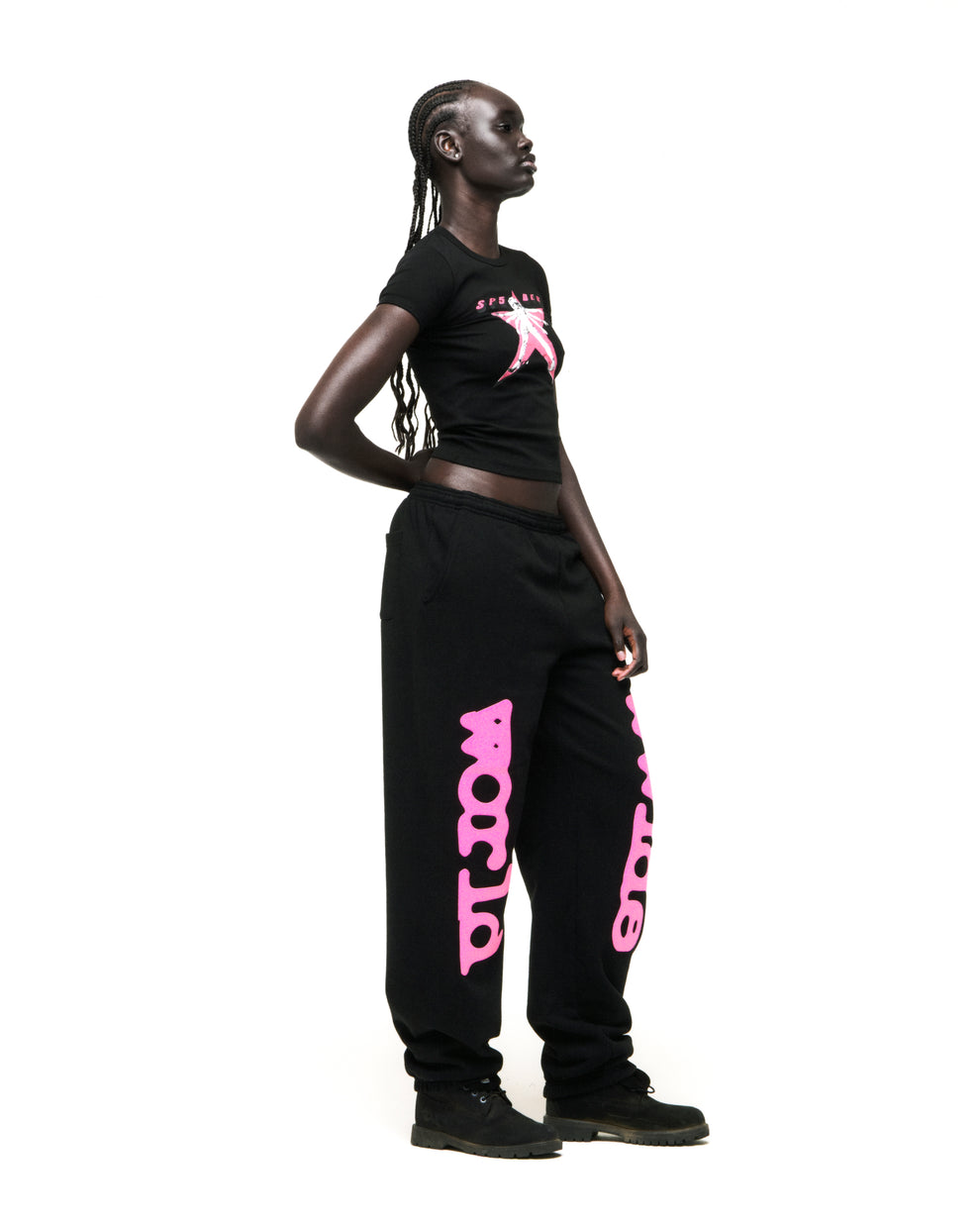 Black cropped cotton/spandex tee with pink "STAR GIRL" graphic, paired with black sweatpants.