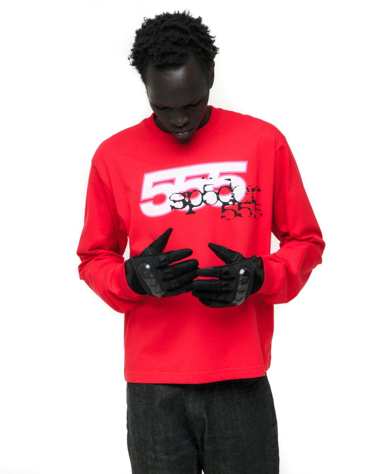 Man in red 555 SP5DER long sleeve tee with white graphic print, ribbed collar/cuffs.