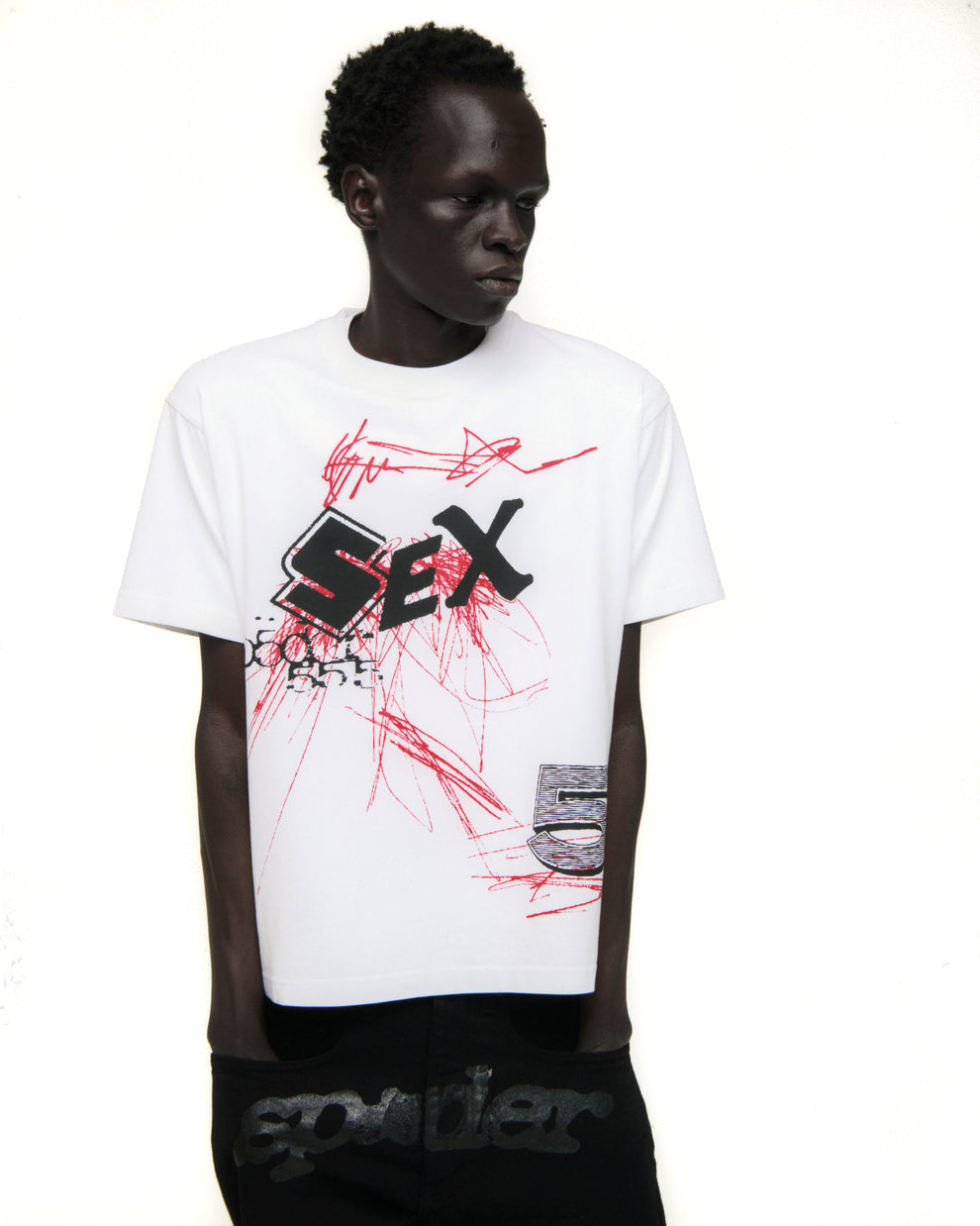 White cotton VIVIENNE TEE with bold black "SEX" graphic and red scribble design.