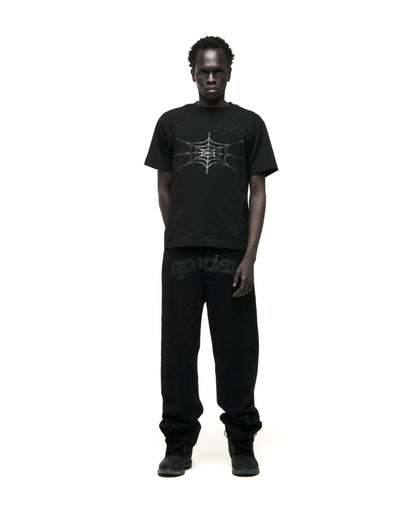 Black cotton tee with rhinestone spiderweb graphic, worn by a man.