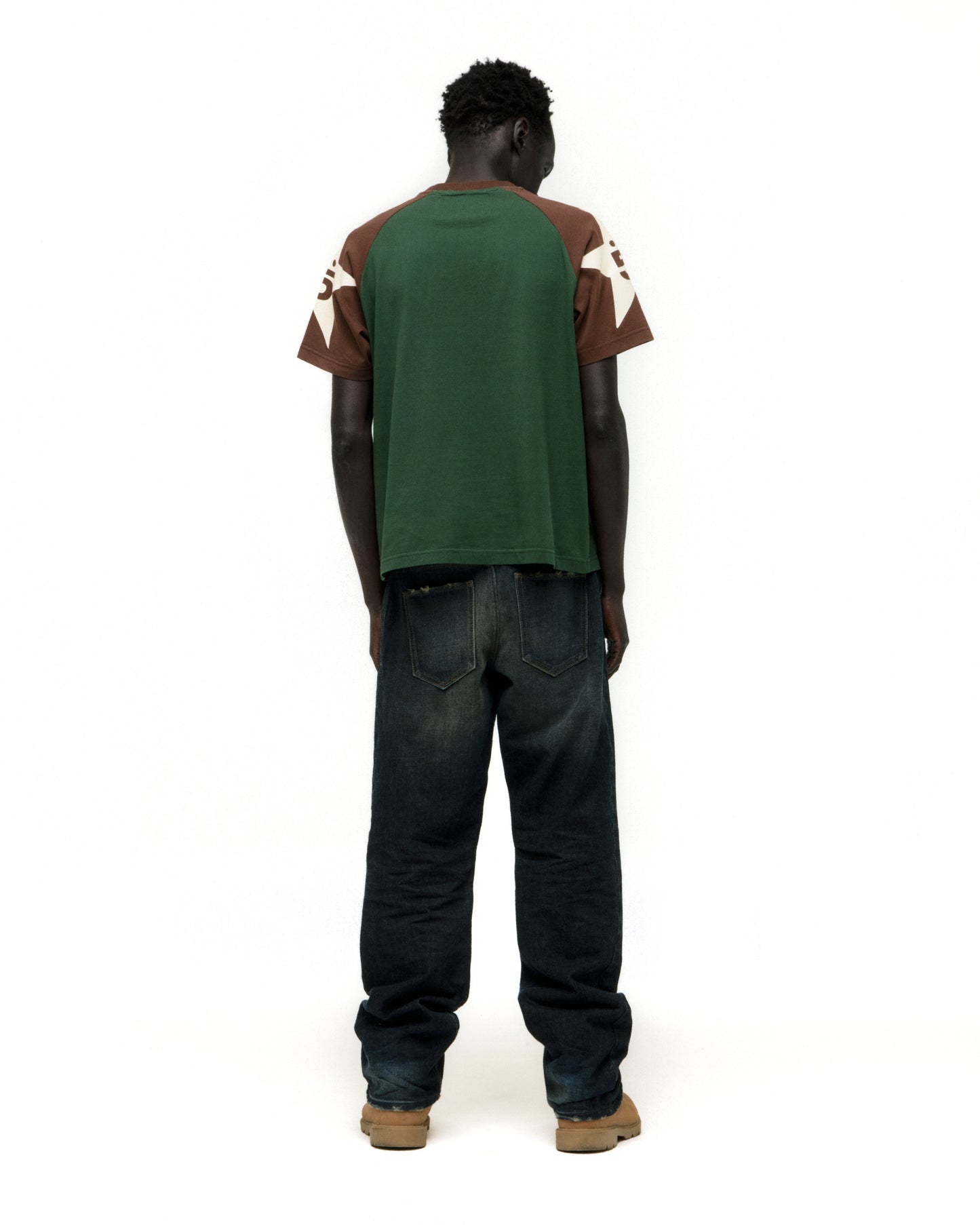 Man modeling 5UKI TEE: green, brown, and white color-block cotton tee with graphic print.