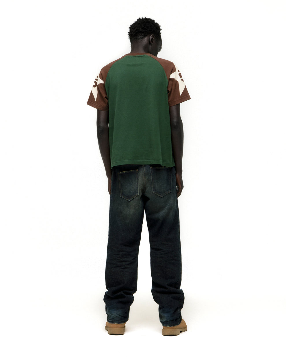 Man modeling 5UKI TEE: green, brown, and white color-block cotton tee with graphic print.