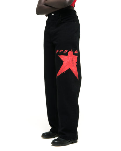 Black denim jeans with a large red star graphic and "SP5D" text on the upper leg.