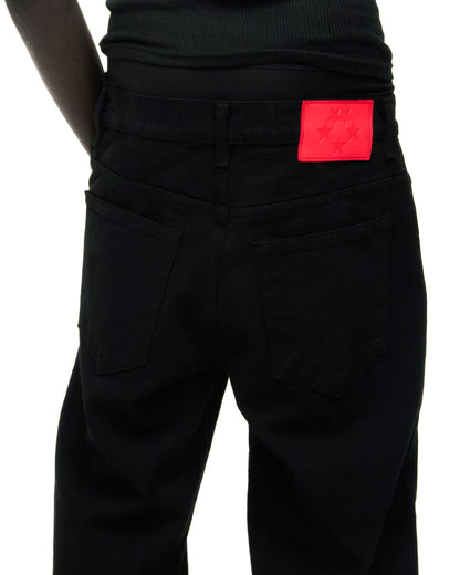 Black V3 DENIM jeans with a red branded leather back patch and five-pocket styling.