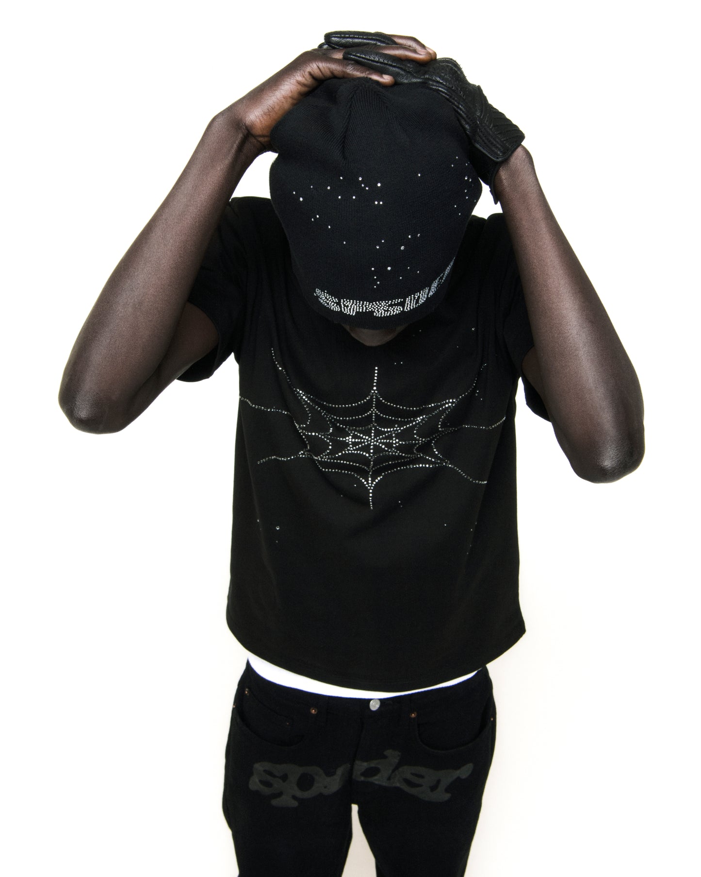 Black cotton tee with rhinestone spiderweb graphic, worn by a person in a black beanie and gloves.