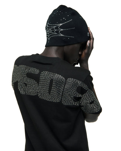 Black acrylic beanie with rhinestone spiderweb and skull designs.