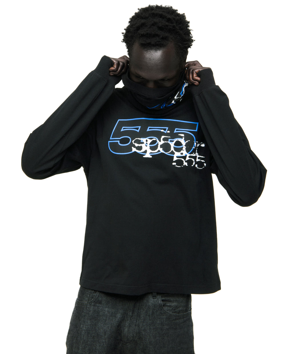 Black 555 SP5DER long sleeve tee with blue graphic print, worn by a person pulling up the collar.