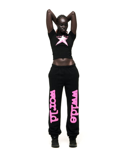 Black cropped tee with pink star graphic, paired with black sweatpants with pink "world wide" text.