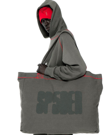 Gray 8oz brushed twill CONTRAST TOTE with SP5DER logo and red contrast stitching, carried by a model.