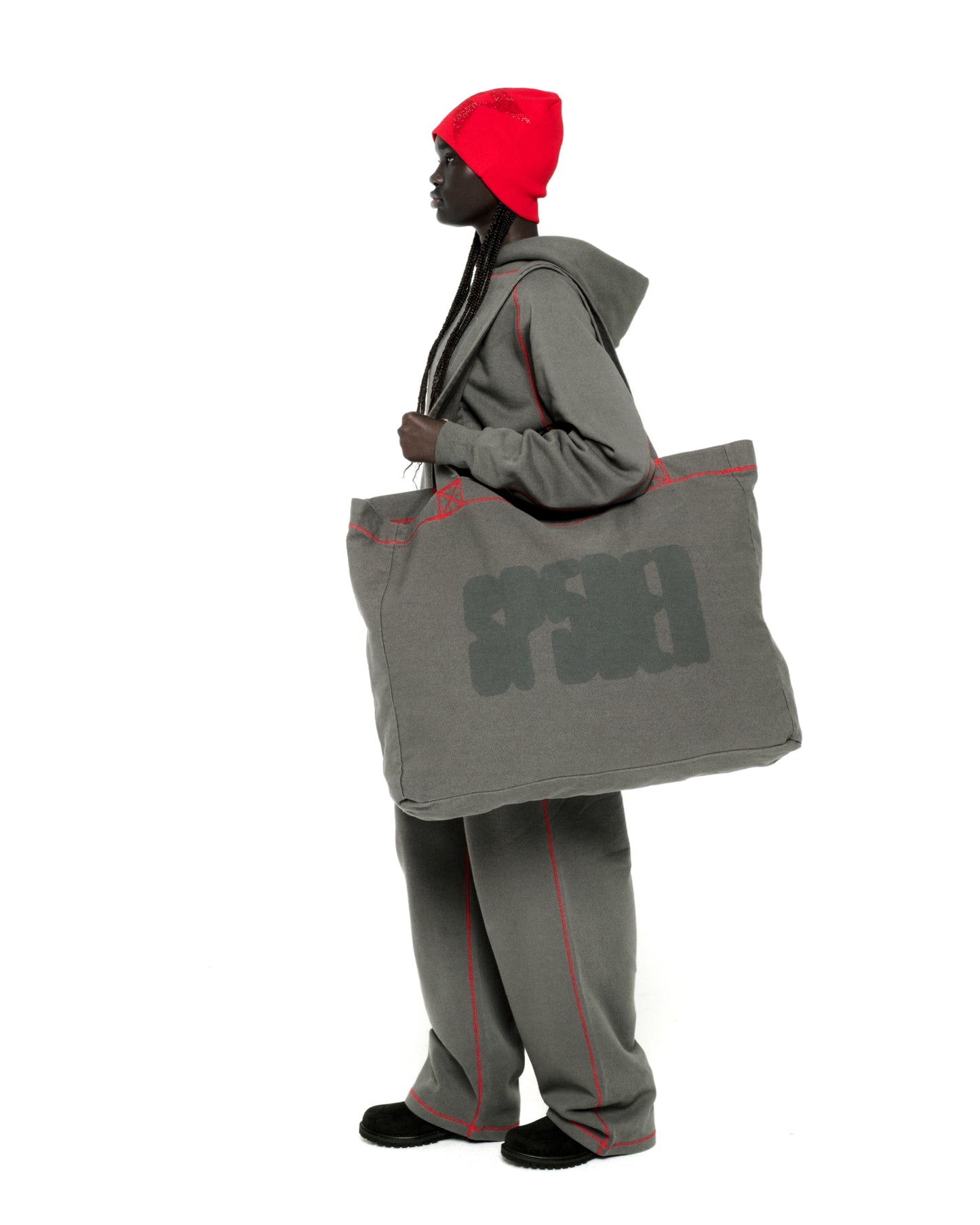 Gray 8oz brushed twill Contrast Tote with SP5DER logo and red contrast stitching, carried by a model.