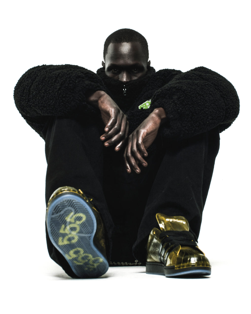 SP5DER x ADIDAS SUPERSTAR in glossy cracked gold patent leather with a spider charm and translucent sole.