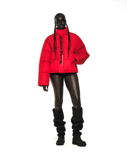 Red TRACKHAWK puffer jacket with reflective rubberized text graphic on front zip and snap placket.