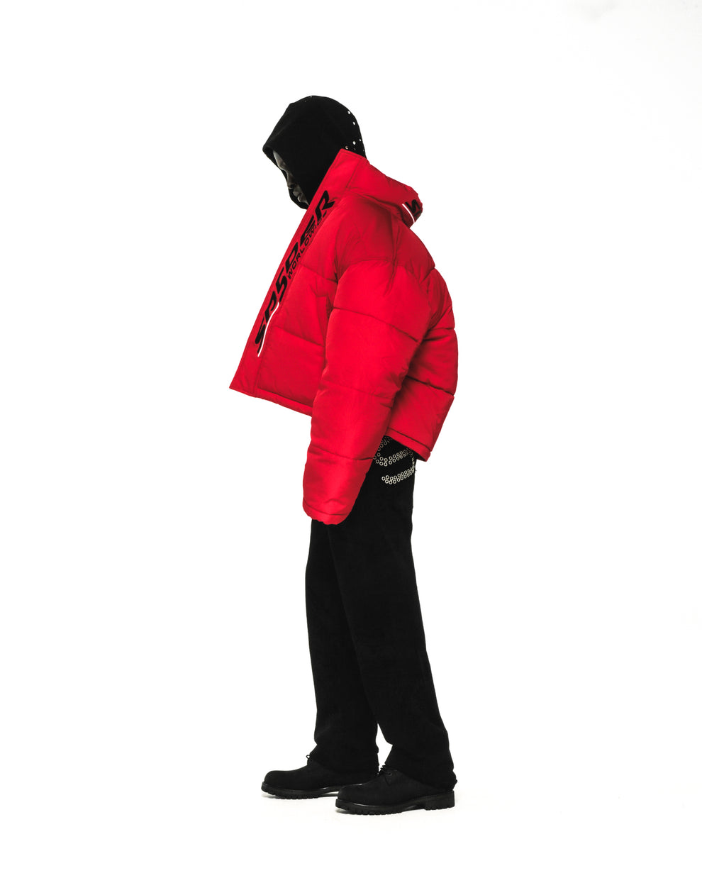 Red TRACKHAWK puffer jacket with reflective text, black pants, and shoes on a mannequin.