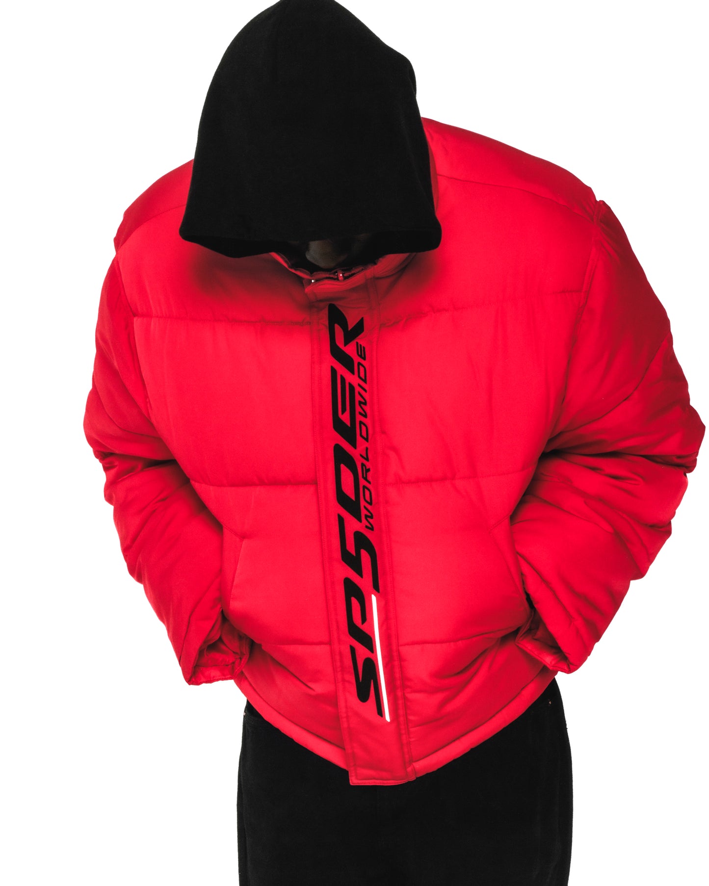 Red TRACKHAWK puffer jacket with black hood, reflective "SP5DER WORLDWIDE" text, and side pockets.