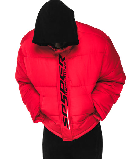 Red TRACKHAWK puffer jacket with black hood, reflective "SP5DER WORLDWIDE" text, and side pockets.