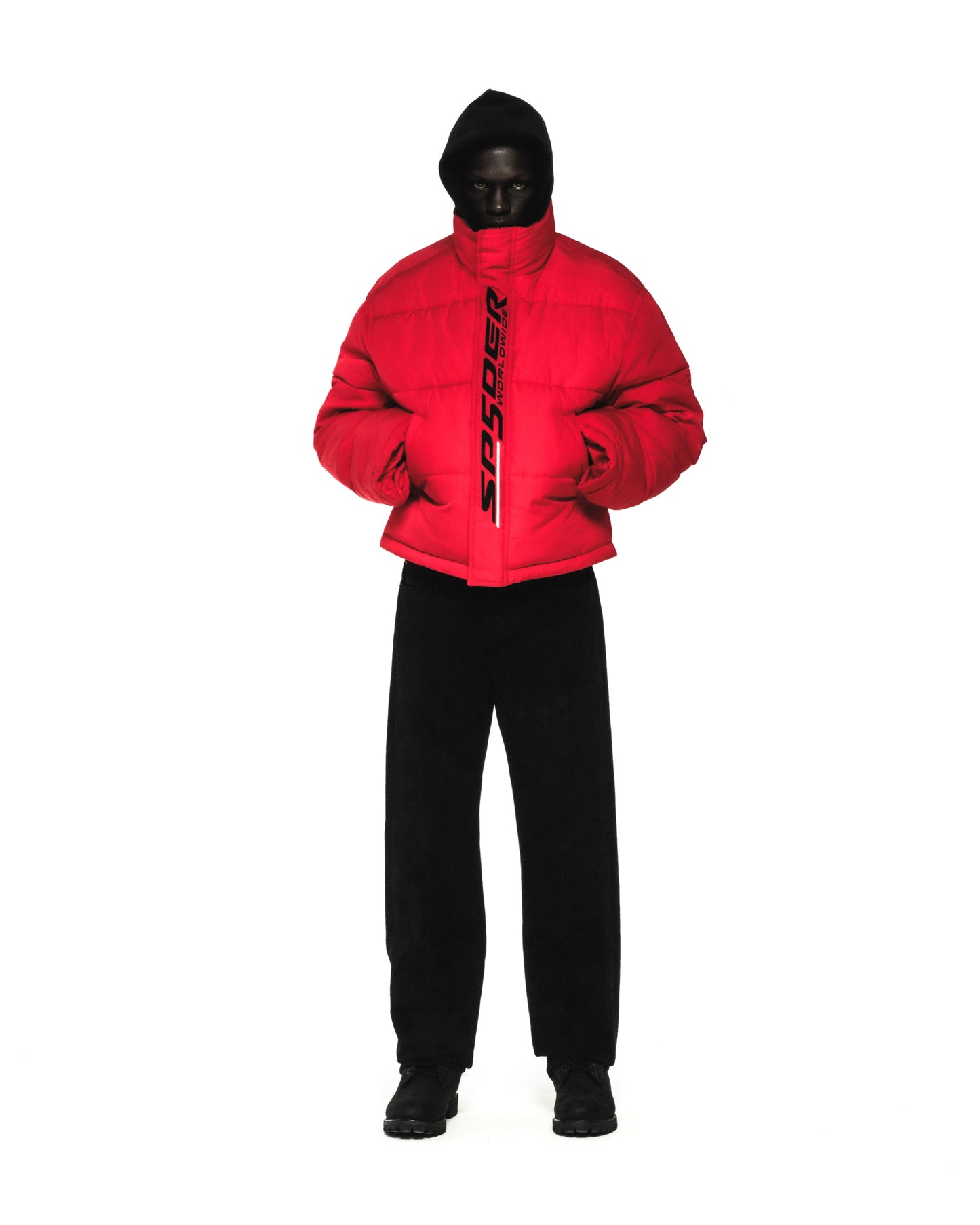 Red TRACKHAWK puffer jacket with reflective "SP5DER WORLDWIDE" text, black hood, and side pockets.