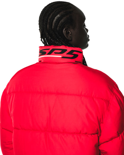 Red TRACKHAWK puffer jacket with "SP5" reflective graphic on the back collar, seen from behind.