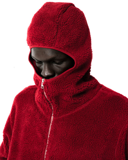 Red sherpa fleece hooded zip-up jacket with narrow front opening and high collar.
