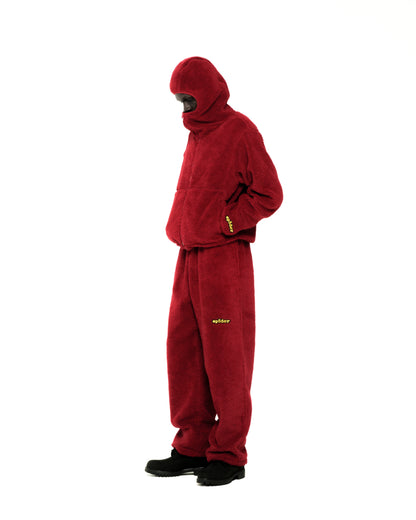 Red teddy fleece zip-up jacket with hood, narrow opening, and matching pants with yellow logo.