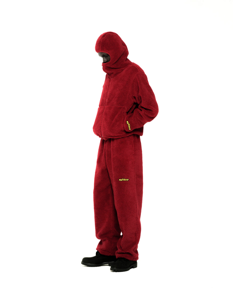 Red teddy fleece zip-up jacket with hood, narrow opening, and matching pants with yellow logo.