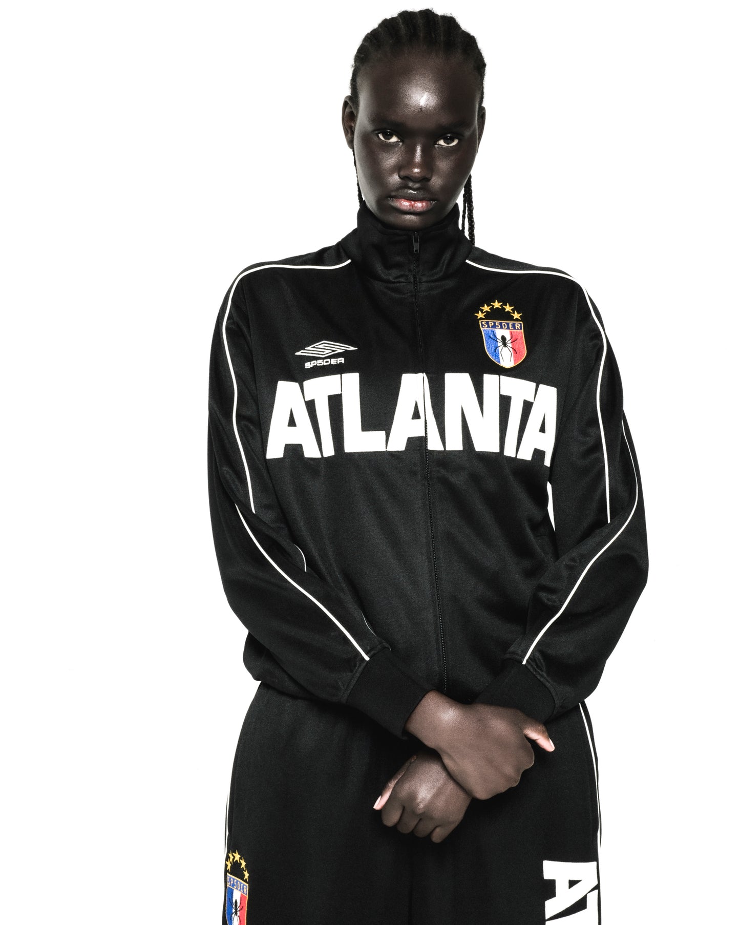 Black polyester ATLANTA TRACK JACKET with white lettering, SP5DER logos, and contrasting sleeve piping.