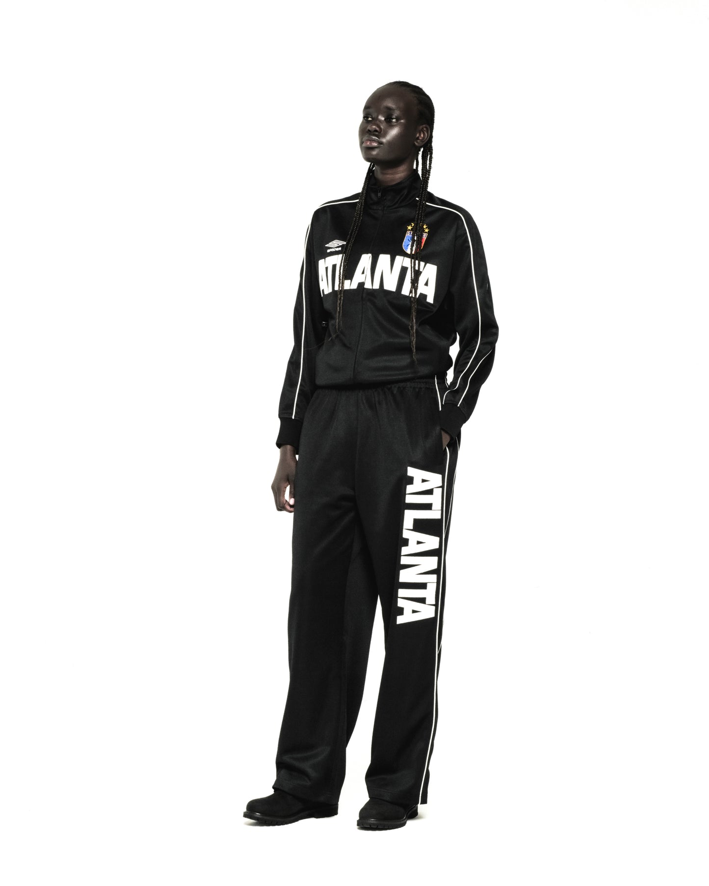 Black polyester ATLANTA TRACK JACKET and matching pants with white lettering, contrasting piping, and SP5DER crest.