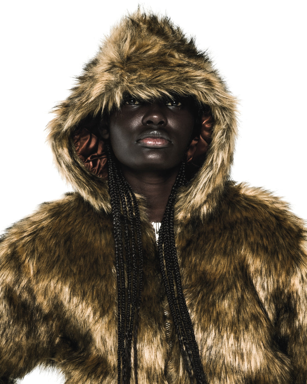 Brown faux fur hooded jacket with quilted satin lining and zip closure.