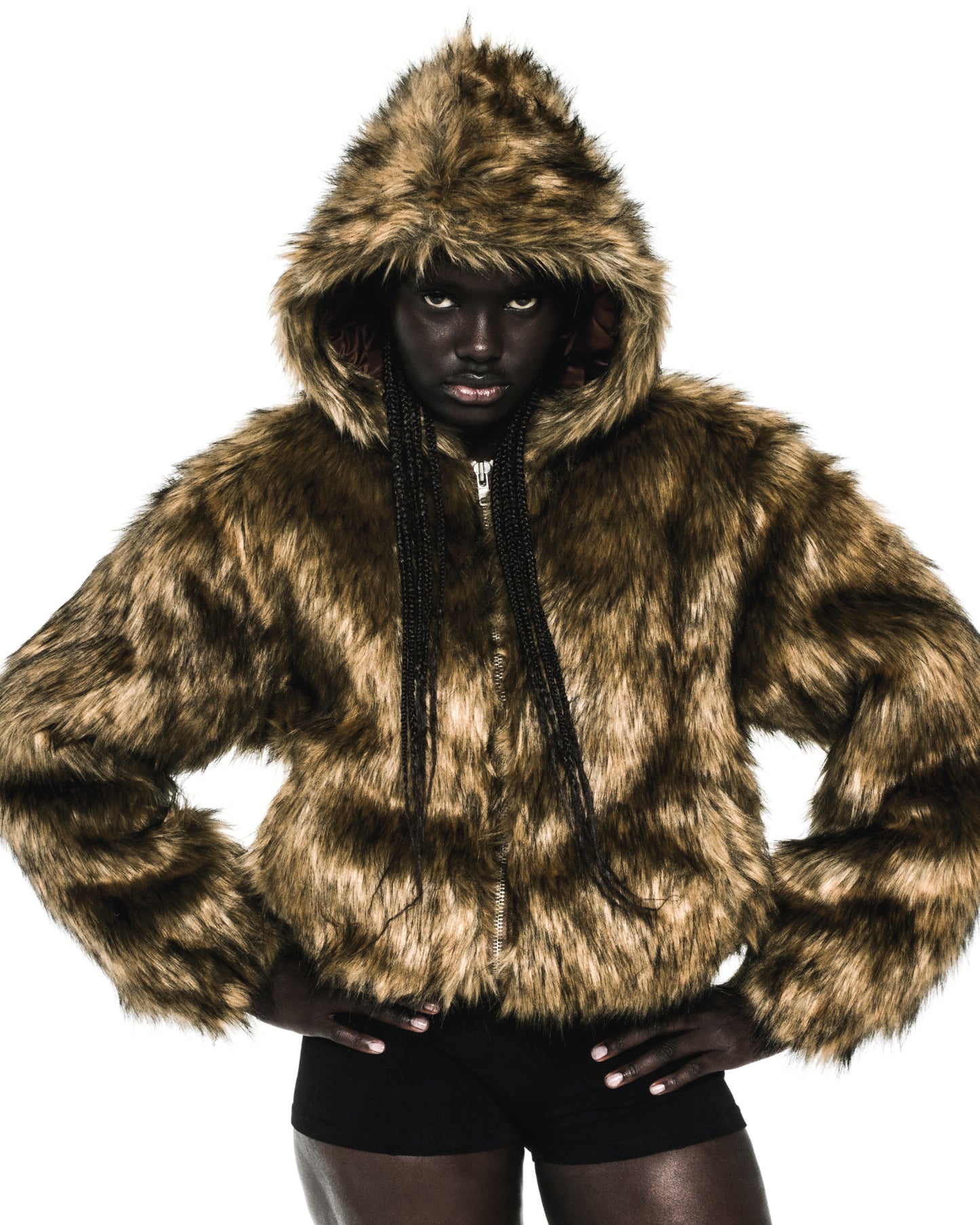 Brown faux fur hooded jacket with zip closure and quilted lining.