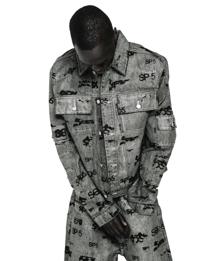 Gray denim trucker jacket with all-over black "SP5" print, silver buttons, and red contrast stitching.