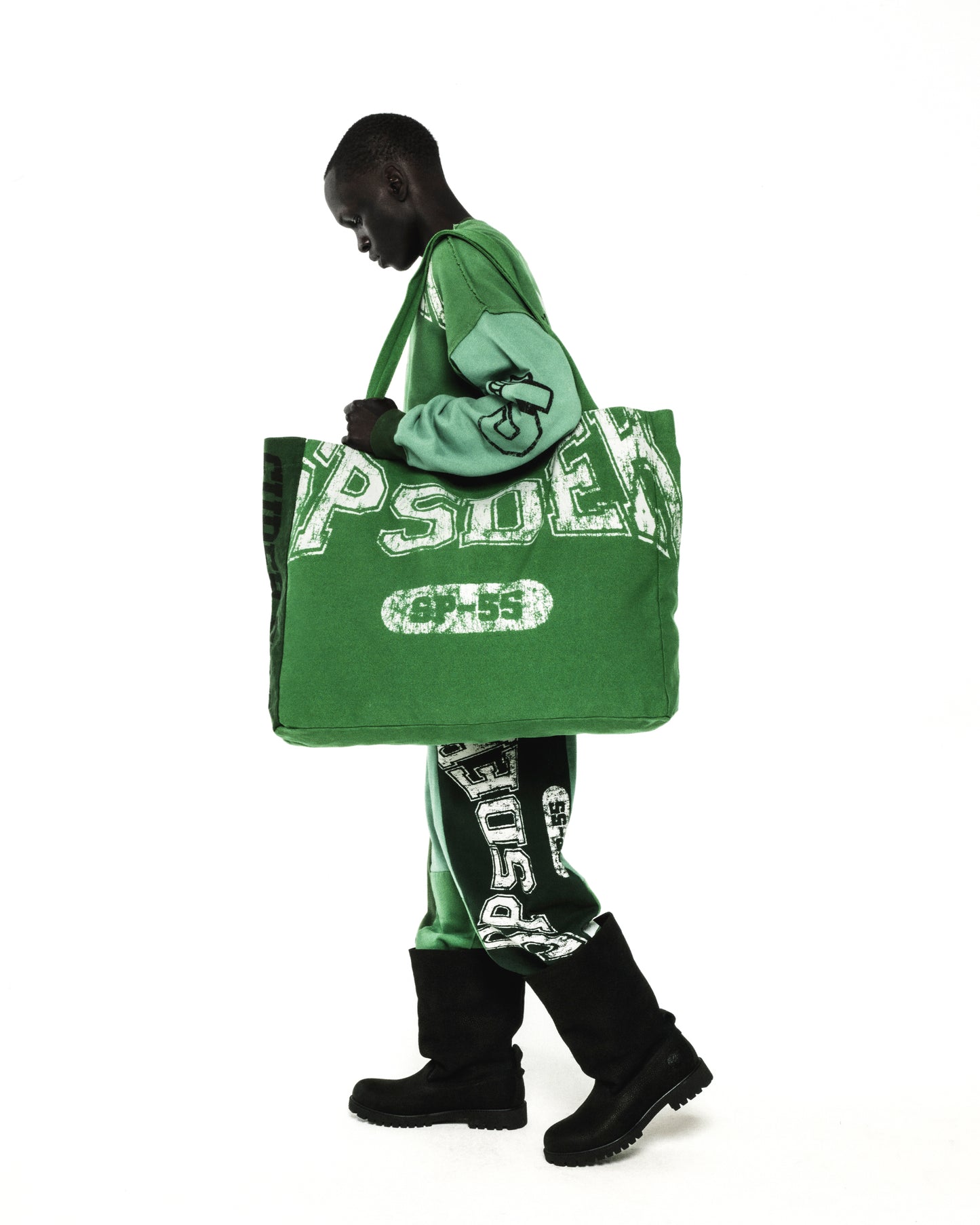 Green 8oz brushed twill SUPERFIVE TOTE with SP5DER graphic, carried by a model.
